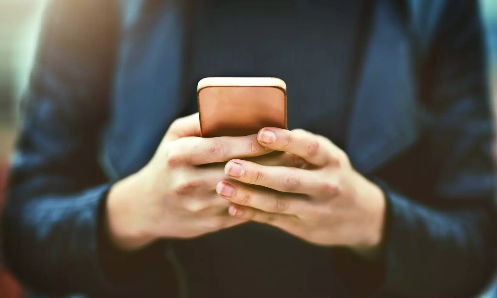 Ein Mann hält ein Smartphone in der Hand
